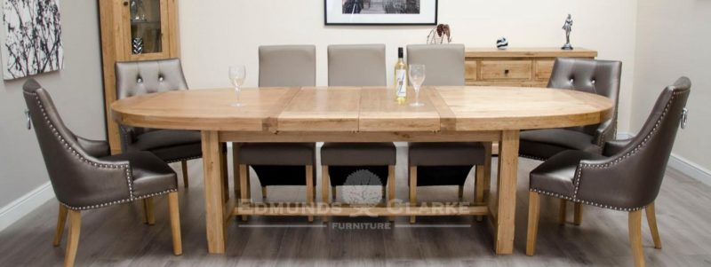 Super oval solid oak extending table with two stowable leaves