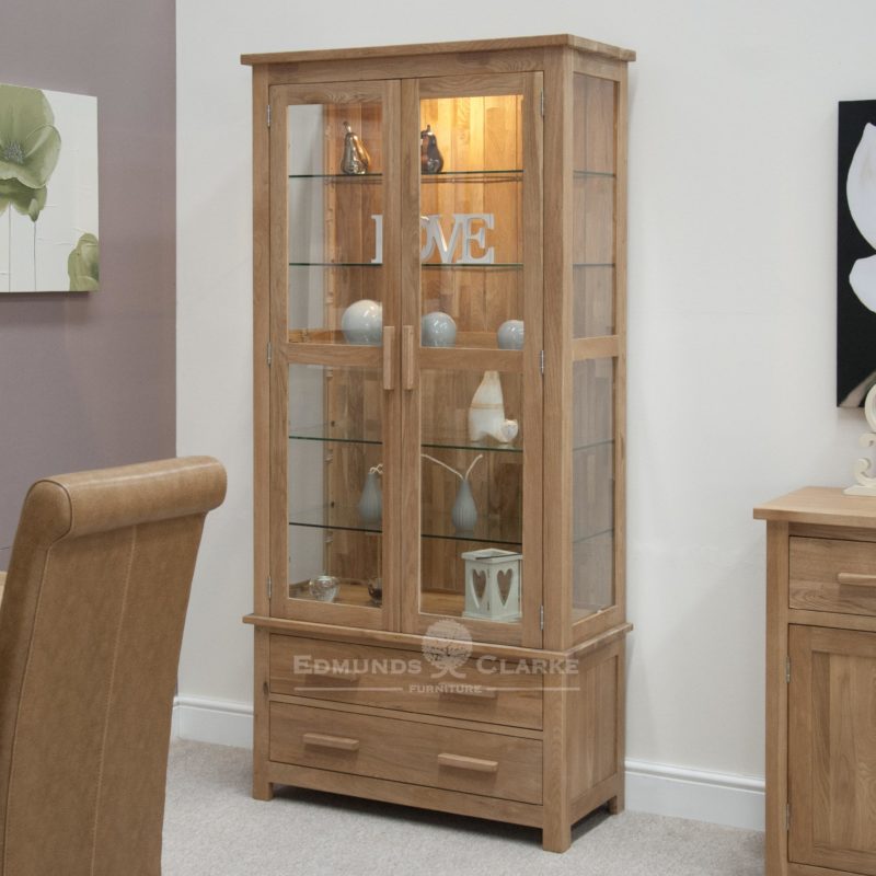 Bury Solid Oak Glass Display Cabinet, bevelled glass at front and sides with LED light to show your treasures off. two handy drawers at bottom, chrome or oak bar handles available