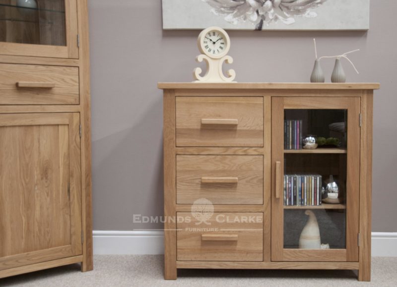 Bury small oak glazed chest, 3 drawers to the left and small glazed door to right with adjustable oak shelves, chrome fitted handle fitted as standard