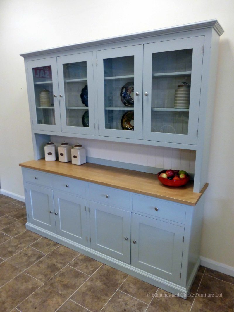 7ft Painted Half glazed dresser. Handmade with solid oak top on the sideboards, painted shelves, 4 drawers with 4 large cupboards below. 4 door glazed rack above painted in southwold sky blue and satin nickel knobs. contrasting white backboards on racking EDM021