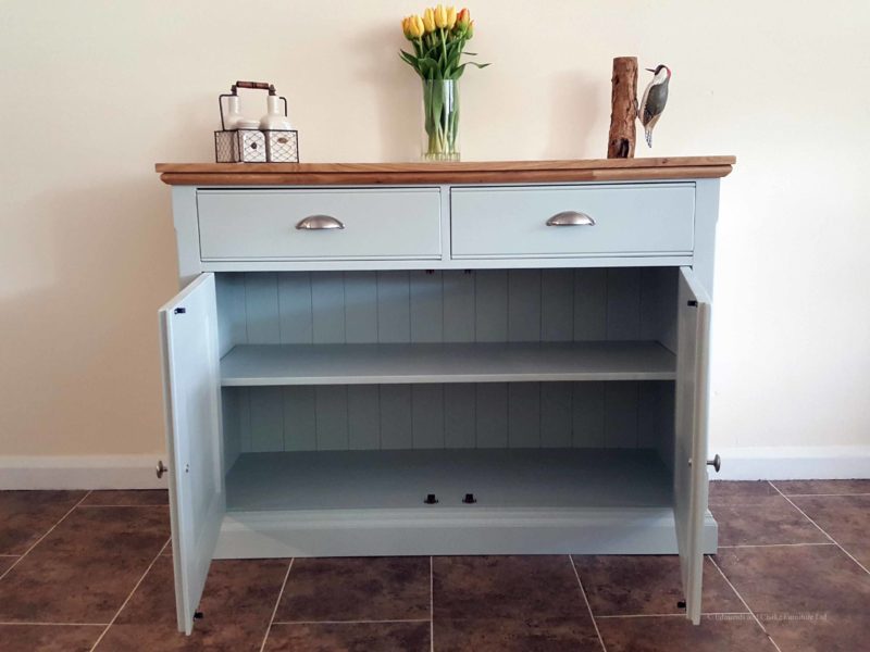 Edmunds Painted 4ft Sideboard. moulded oak top. 2 drawers and 2 doors with adjustable shelves within. image showing southwold sky with chrome cup handles and knobs. choice of handles. EDM040