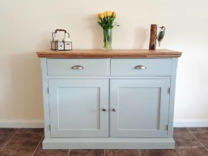 Edmunds Painted 4ft Sideboard. moulded oak top. 2 drawers and 2 doors with adjustable shelves within. image showing southwold sky with chrome cup handles and knobs. choice of handles. EDM040