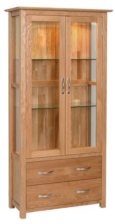 Norwich Oak Glass Display Cabinet.contemporary shaker style straight lines and shaped edges on tops. shaped chrome bar handles.Glass shelves are adjustable. 2 handy drawers at the bottom NNG40