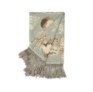 Voyage Maison Nocturnal Seathistle Throw moths on a duck egg blue background with gresy tassel edge