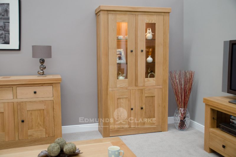 Hadleigh solid oak chunky display unit with lights. Light lacquered finish. square rustic knobs, adjustable glass shelves in the top and solid oak shelves in bottom cupboard