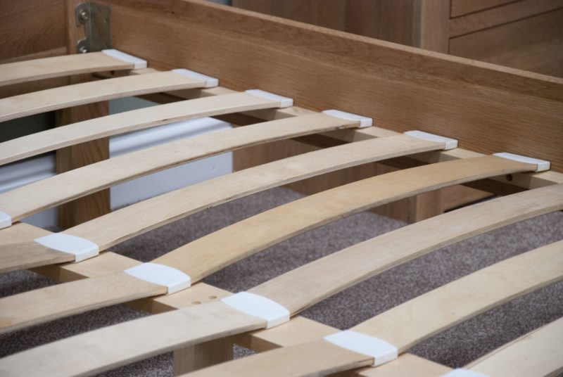 Image of typical bed slats in Edmunds & clarke Oak bed range. slats fit into cups to keep in place