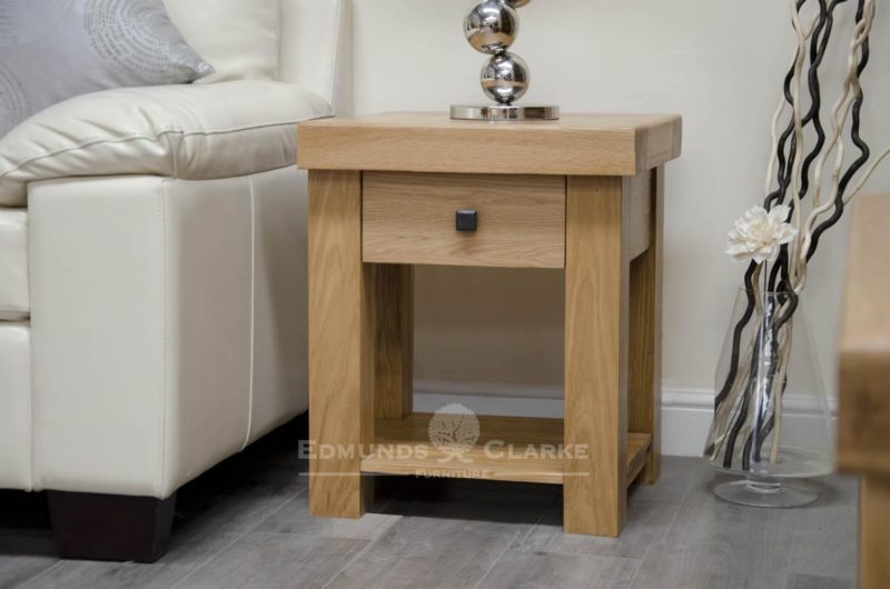 hadleigh solid oak lamp table with drawer. Light lacquered chunky oak with shelf under and black rustic square knob