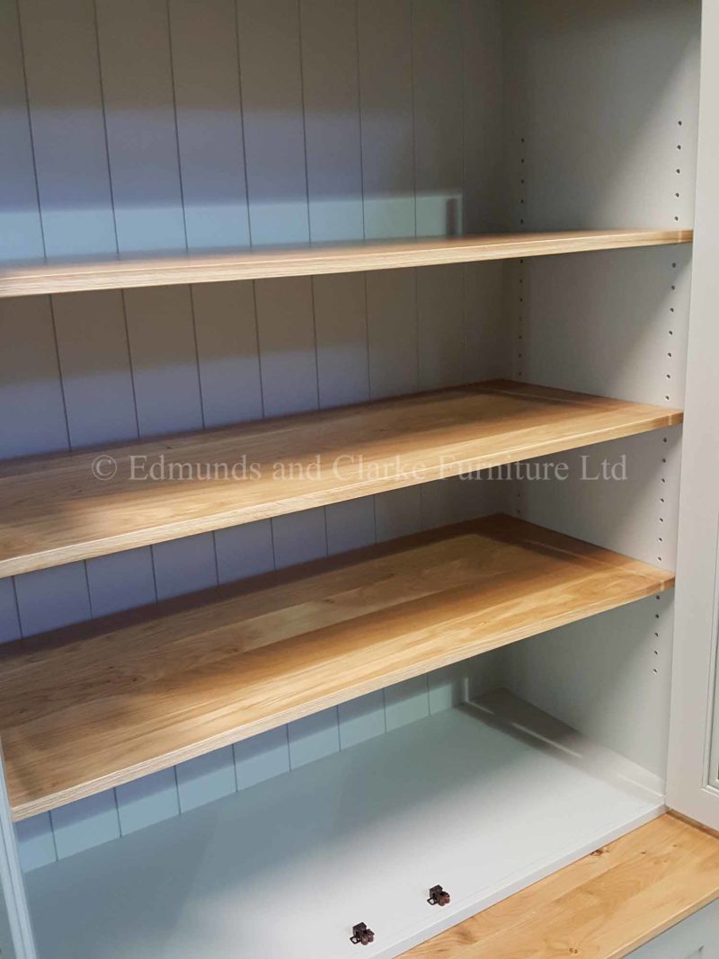 Workstation and shelving with glazed doors and adjustable shelves painted