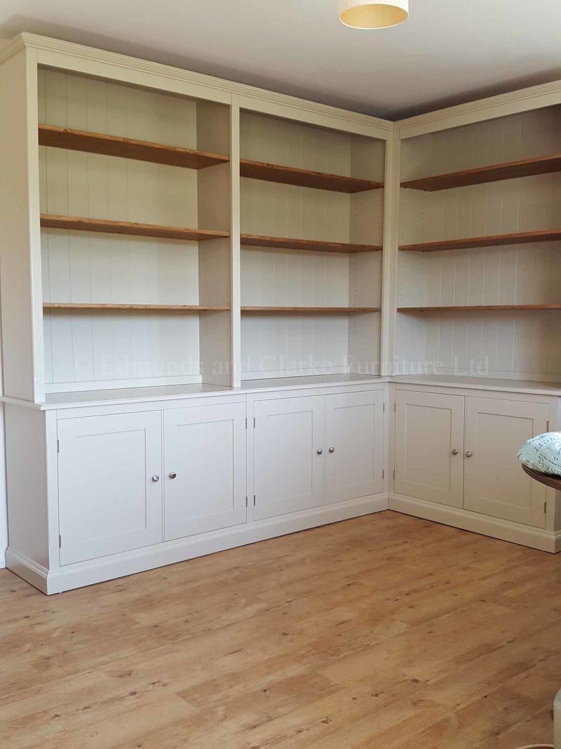 Corner painted bookcase open shelving with cupboards below