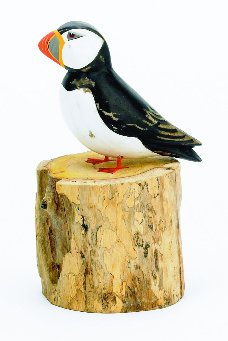 Archipelago Small Puffin Straight Wood Carving. sitting on wood block