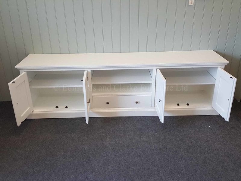 Painted white tv entertainment stand wide with cupboards and drawer and open central space