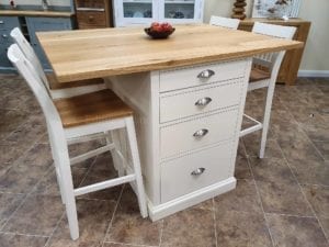 Breakfast bar with four drawers and space for four bar stools, painted ivory with solid oak top
