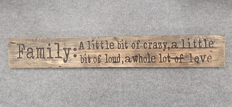 A Rustic Wooden Plaque quoting Family, A little bit of crazy, a little bit of loud, a whole lot of love, engraved