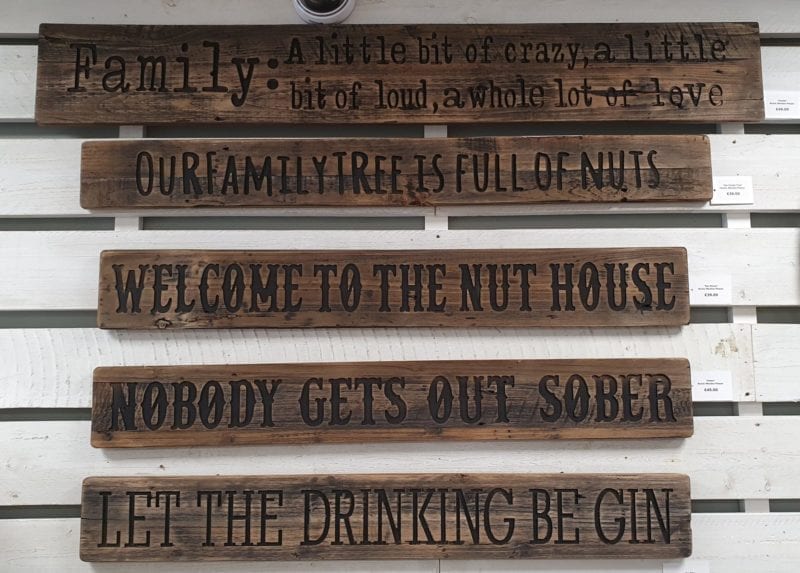 Five Rustic Wooden engraved Plaques, hung on wall, grouped together