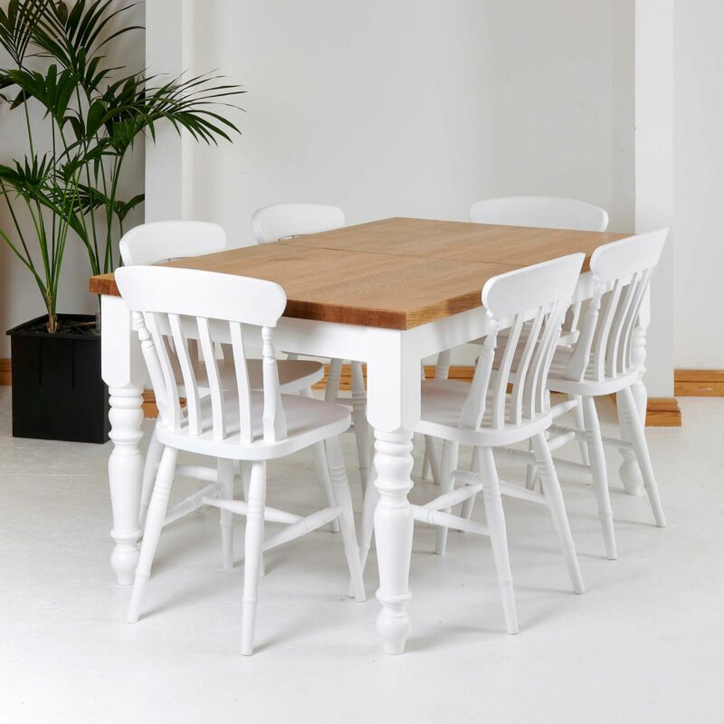 Edmunds dining table with oak top and white turned legs. Edmunds & Clarke Furniture