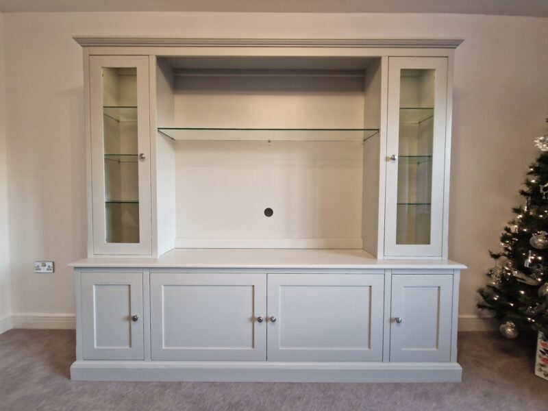 TV Entertainment Unit with glazed top and glass shelves and long cupboards under. Edmunds & Clarke Furniture